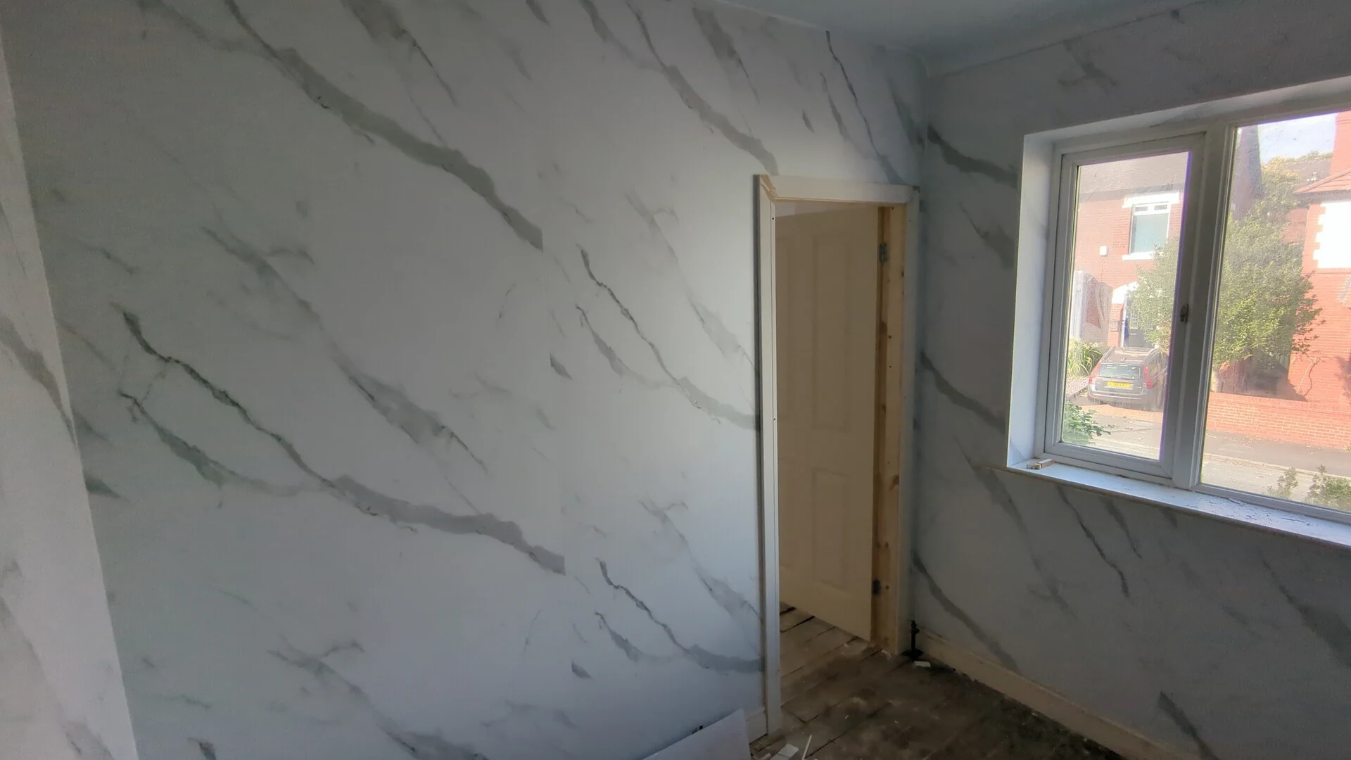 Interlocking PVC bathroom wall cladding fitted around the ensuite doorway in Doncaster