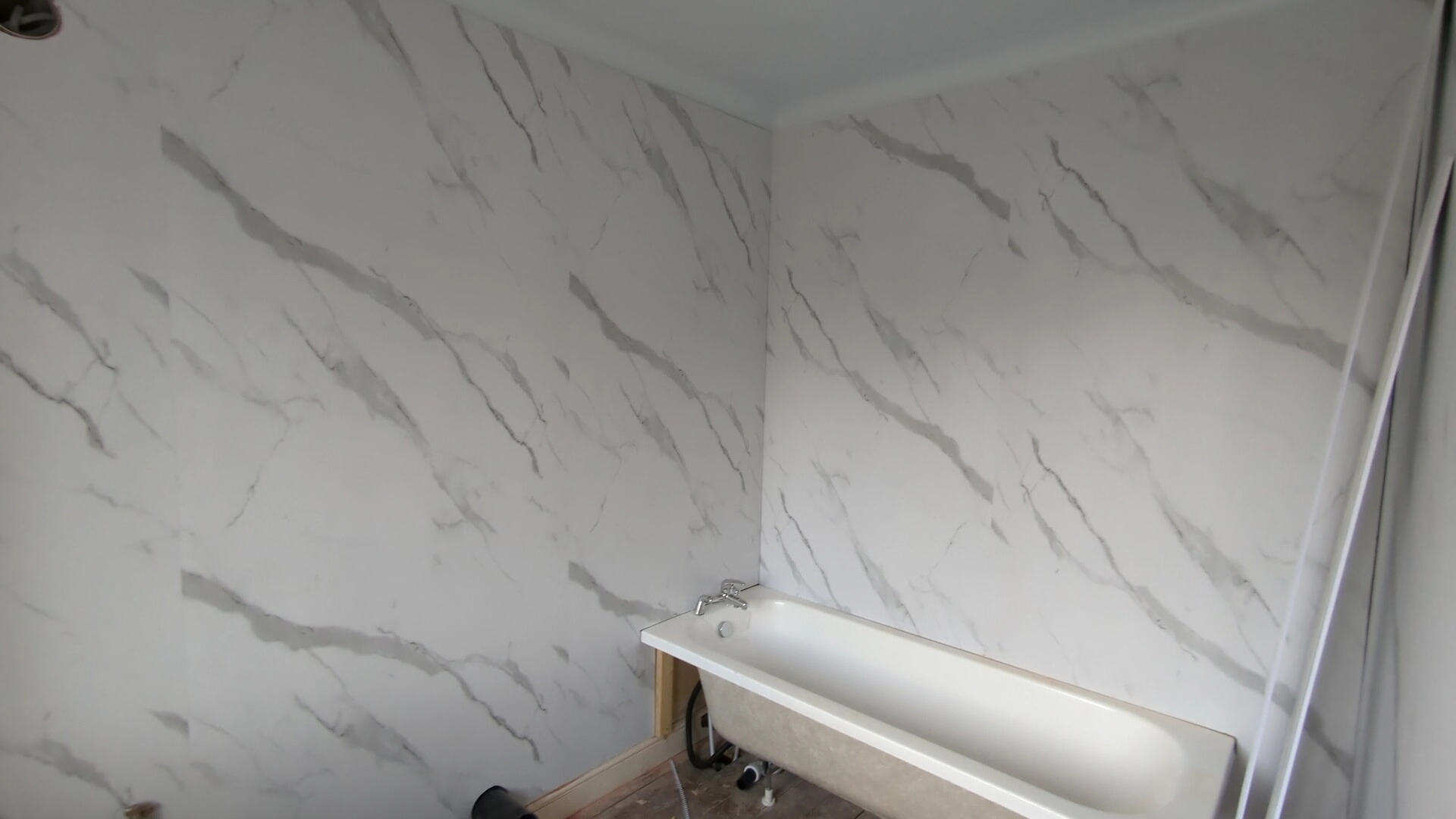 Marble-effect PVC bathroom wall panels fitted across two walls of a Doncaster ensuite above the bath