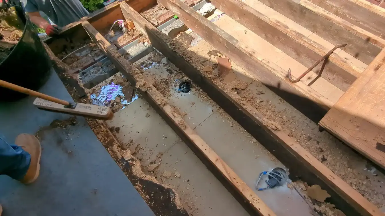 Flat roof stripped back and cleared out, with the joists exposed for inspection