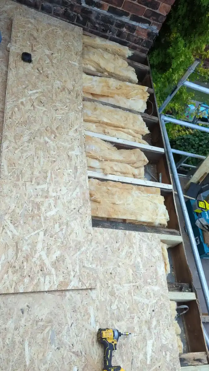 OSB boarding being laid over the new flat roof insulation