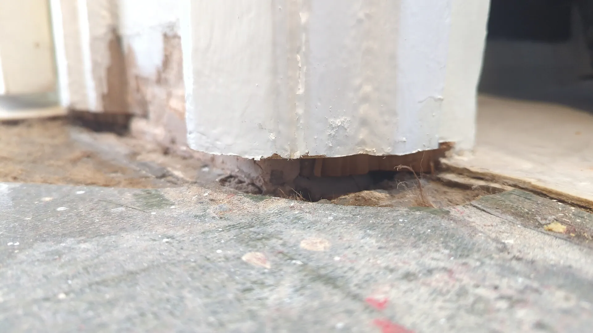 Door lining undercut at floor level with a clean gap for the laminate flooring to slide beneath