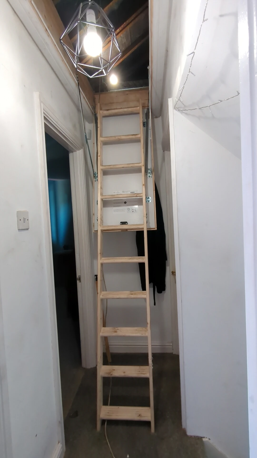 Timber folding loft ladder installed and pulled down into a landing in South Kirkby