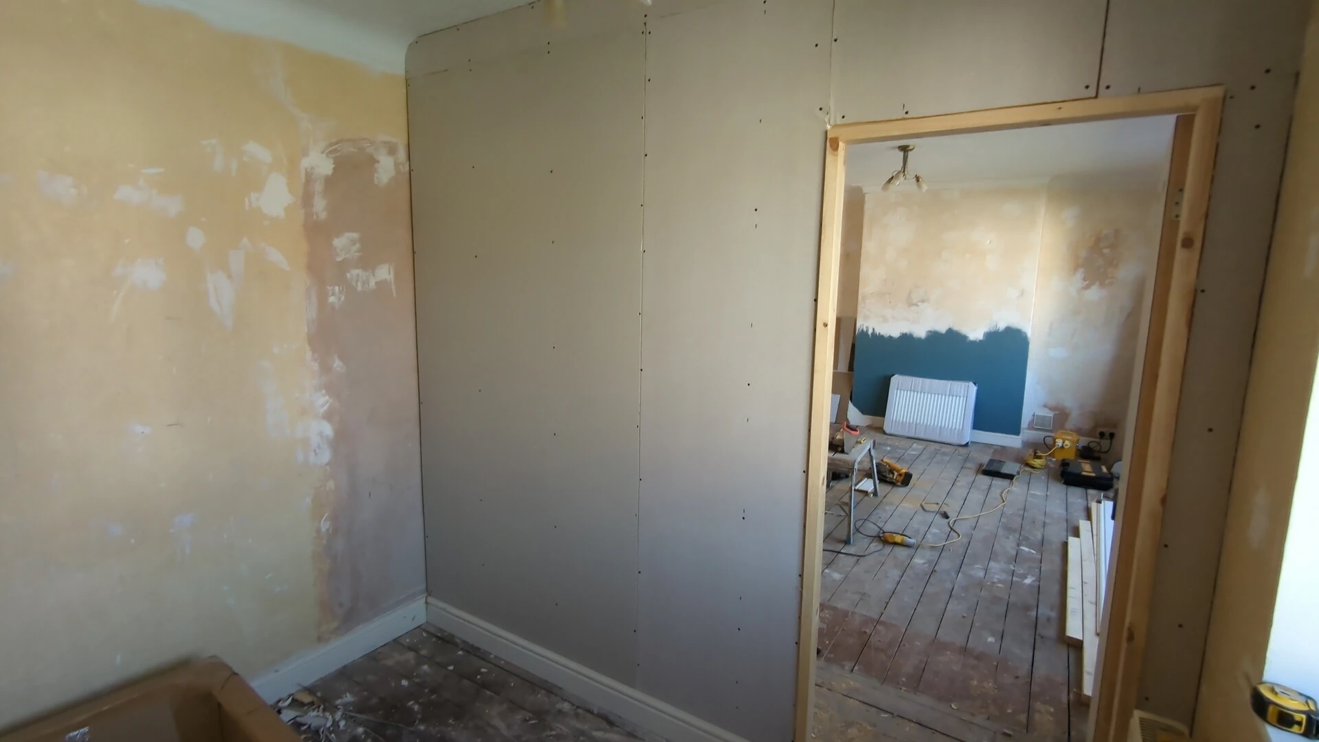 Timber door lining fitted in a plasterboarded stud partition wall