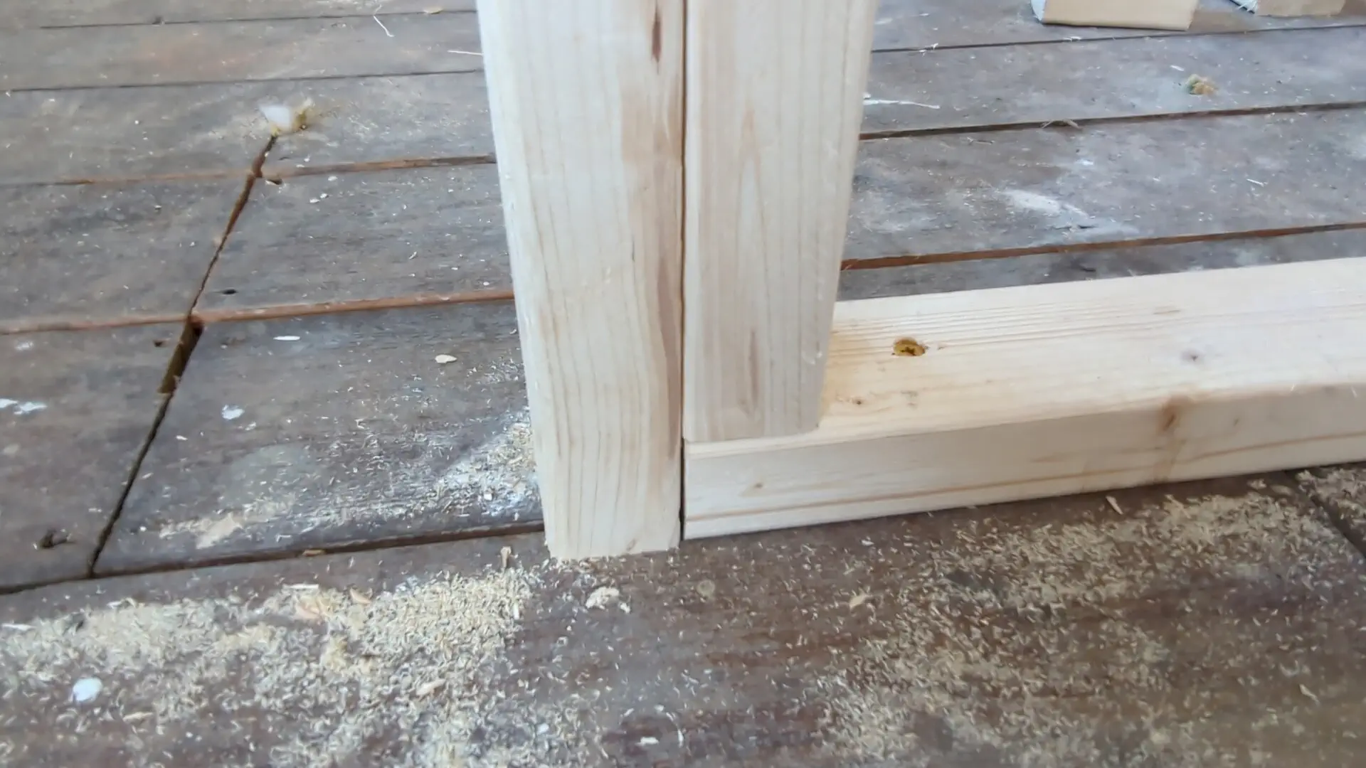 Full-height door stud overlapping and tied into the sole plate of the partition wall