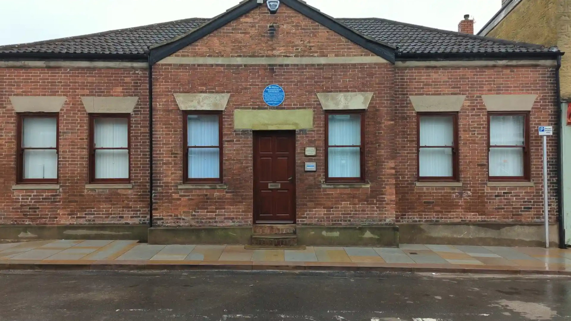 Repaired timber windows on the front elevation of a Pontefract office building after sill repairs and refinishing