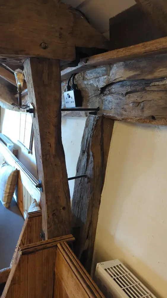 Split oak beam drilled and pulled back together with threaded bar at The Counting House