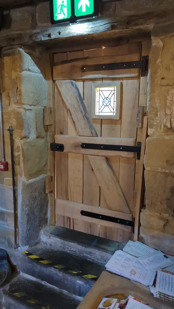 Interior of the solid oak ledged and braced door with stained-glass light at The Counting House