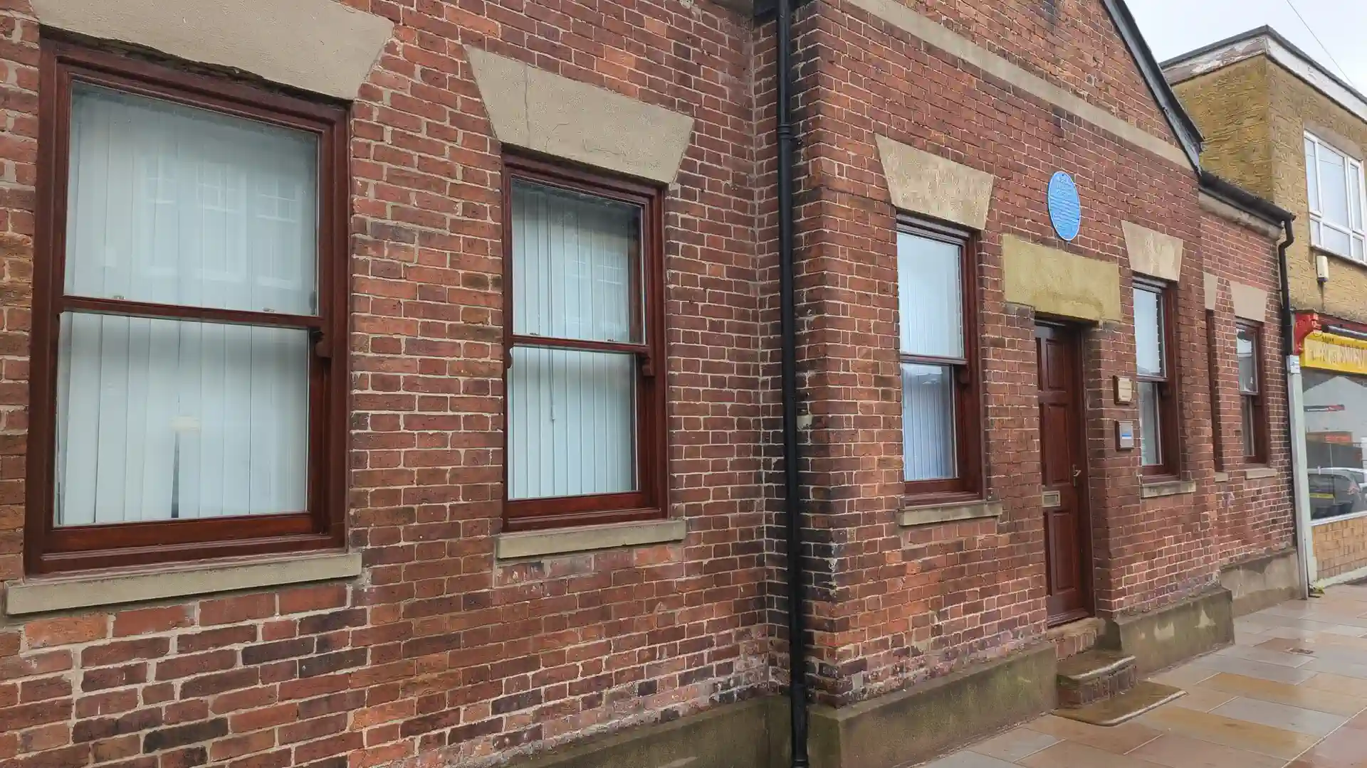 Repaired and refinished timber sash windows along a Micklegate elevation in Pontefract