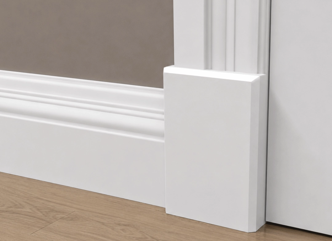 White moulded skirting board running into a plinth block at a door architrave