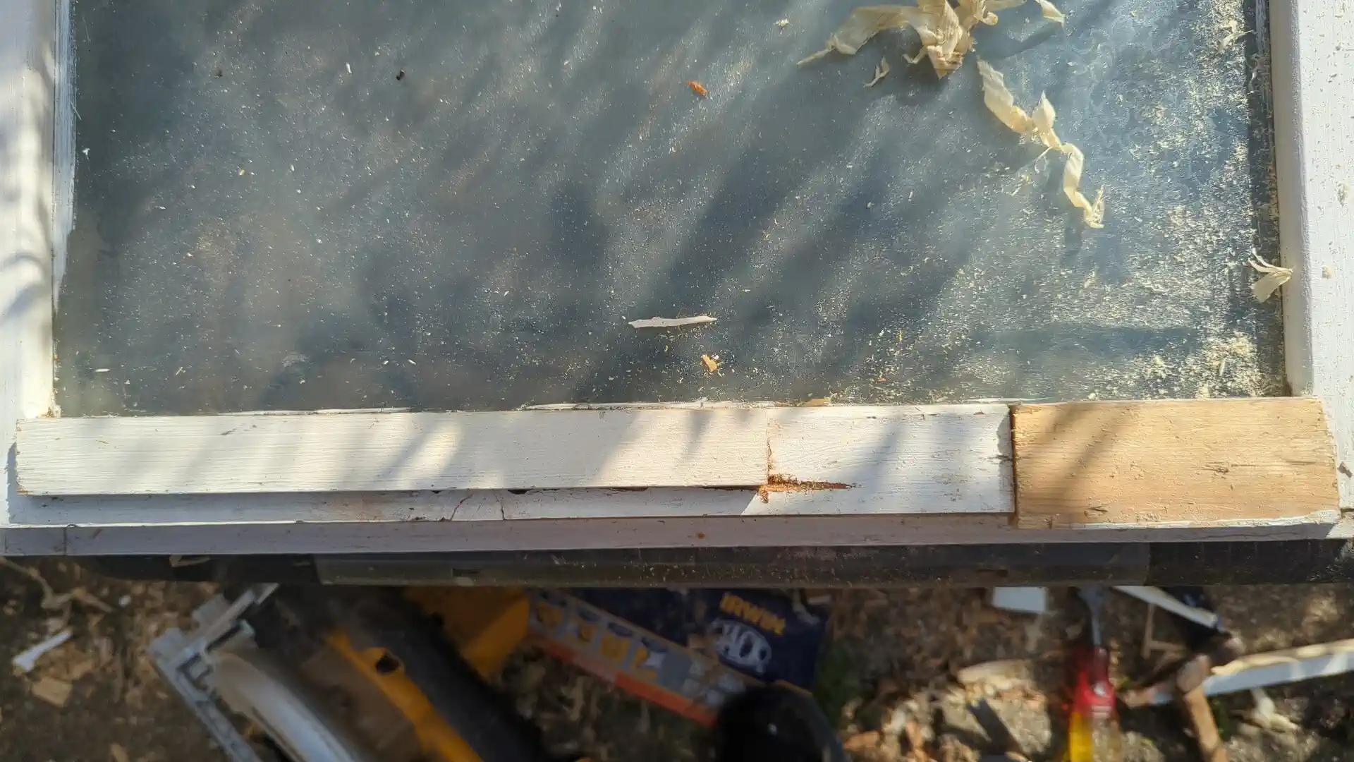 New timber let into the bottom rail of a casement window beside the retained original timber, Greengates